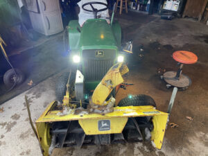 John Deere 112 with Snowblower, new headlights and the left wheel off